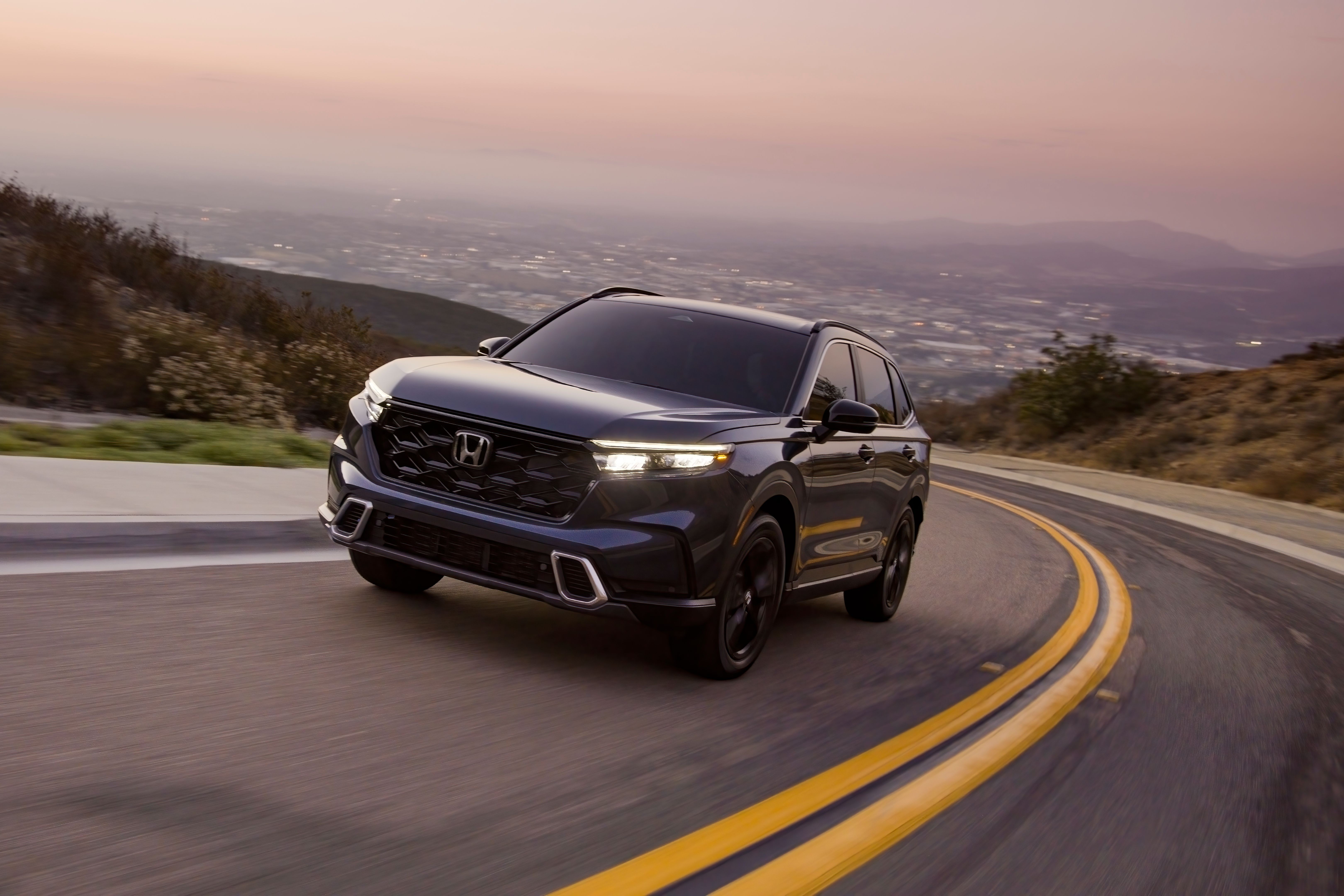 Front three quarter view of a 2023 Honda CR-V Sport Touring highlighting its elegant and conservative design