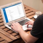 Man researching healthcare costs on a laptop using a cost compare website