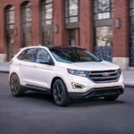 2018 Ford Edge White Driving Front Quarter ・ Photo by Ford