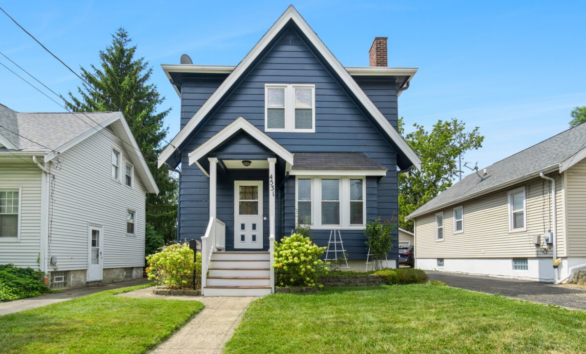 Exterior view of a modern home with a well-maintained lawn and landscaping, showcasing typical suburban neighborhood comparables.