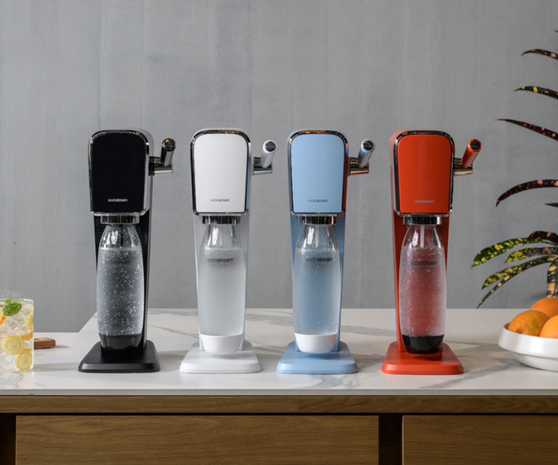 SodaStream Art models in black, white, blue, and red, lined up on a countertop