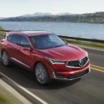 2019 Acura RDX on a paved road, showcasing its luxurious design and all-wheel-drive capability