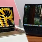 MacBook Air 13 M3 open on a white table with a pink background on the left half of a split image, with a MacBook Pro 14-inch M4 open on a wooden table with a grey background on the right.