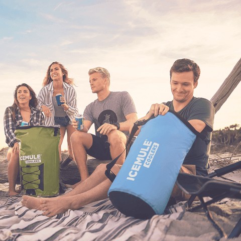 Group of friends enjoying the beach with an ICEMULE Pro Large cooler