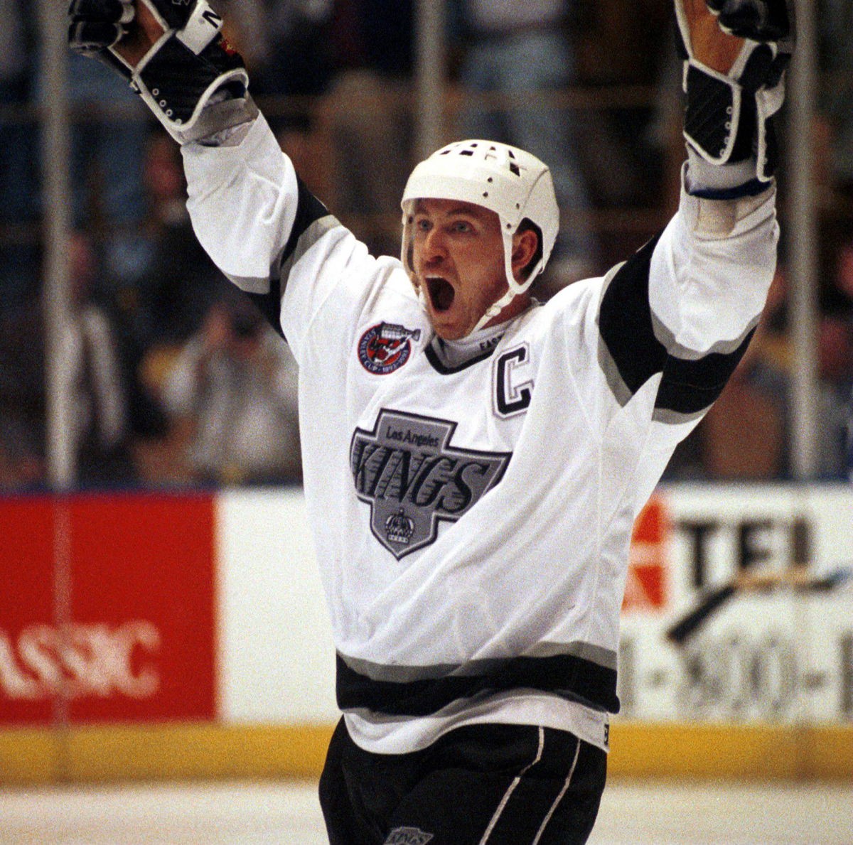 Wayne Gretzky in his New York Rangers jersey celebrating a goal, highlighting his legendary career.