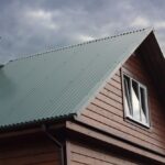 Close-up of a steel roof panel highlighting its durability compared to shingles.