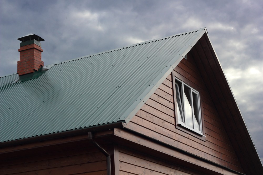 Close-up of a steel roof panel highlighting its durability compared to shingles.