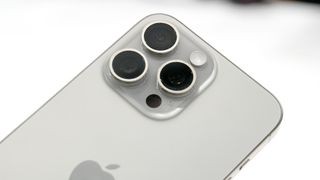 A detailed view of the triple-lens camera system on the iPhone 15 Pro