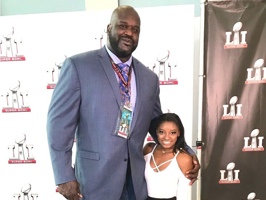 Simone Biles and Shaquille O'Neal height comparison at gymnastics event