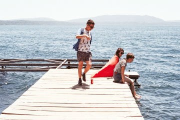 Hikers with backpacks walking in mountainous countryside