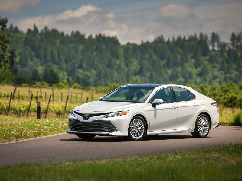 Toyota Camry silver metallic driving on road Photo by Toyota