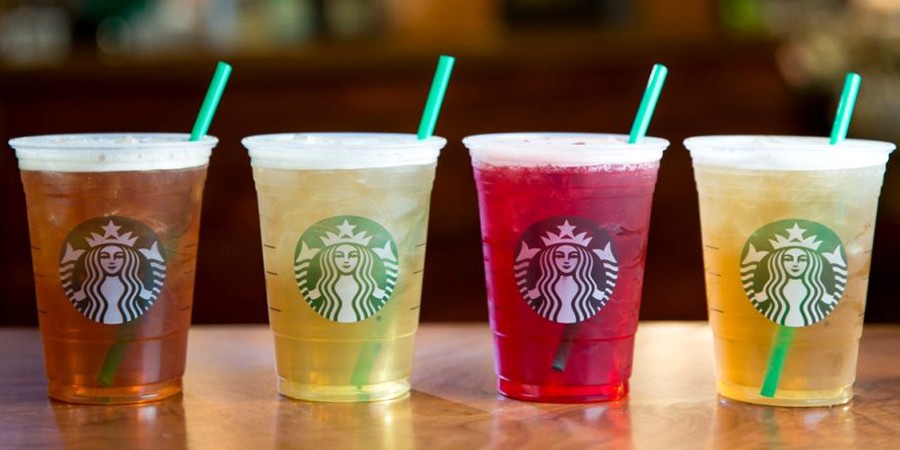 A close-up shot of a glass of iced peach green tea, showcasing its refreshing appearance.