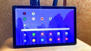 Samsung Galaxy Tab A7 on a desk displaying its home screen