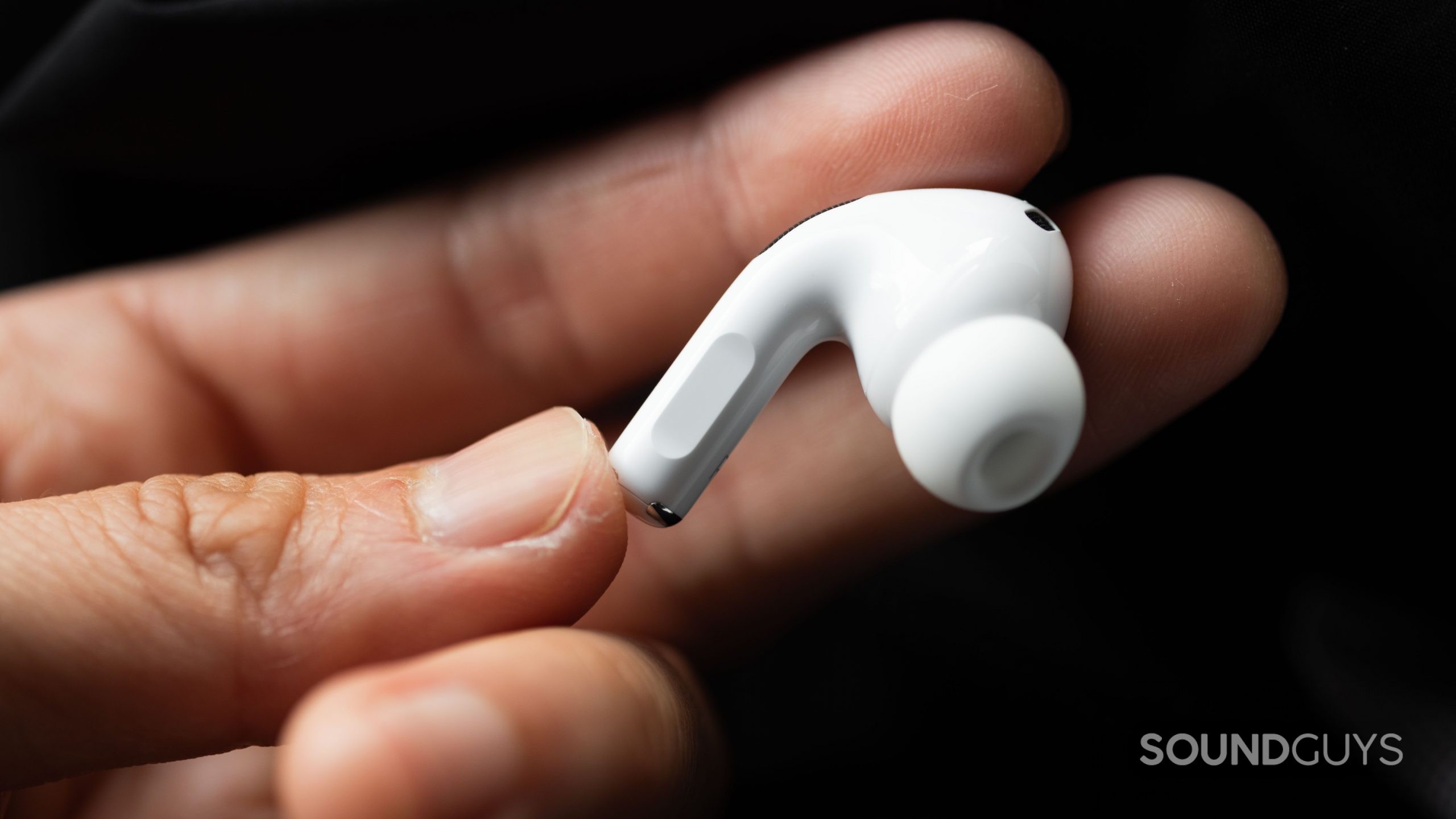 A Hand Holds the Right Earbud of the Apple AirPods Pro (2nd generation) to Show Off the Stem