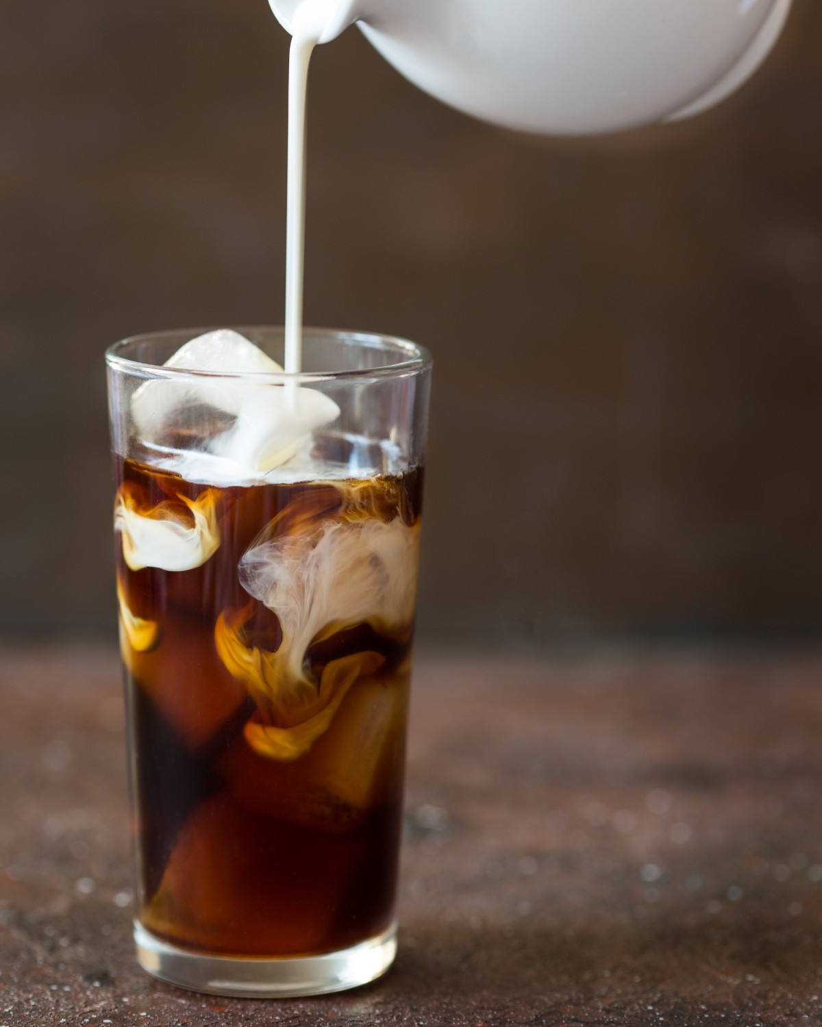 Iced cold brew coffee with a splash of creamer
