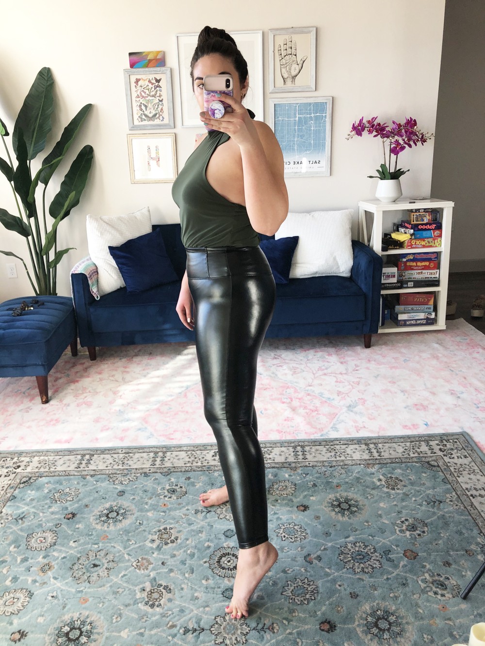 Woman in high-waisted black leggings and a crop top, highlighting the silhouette