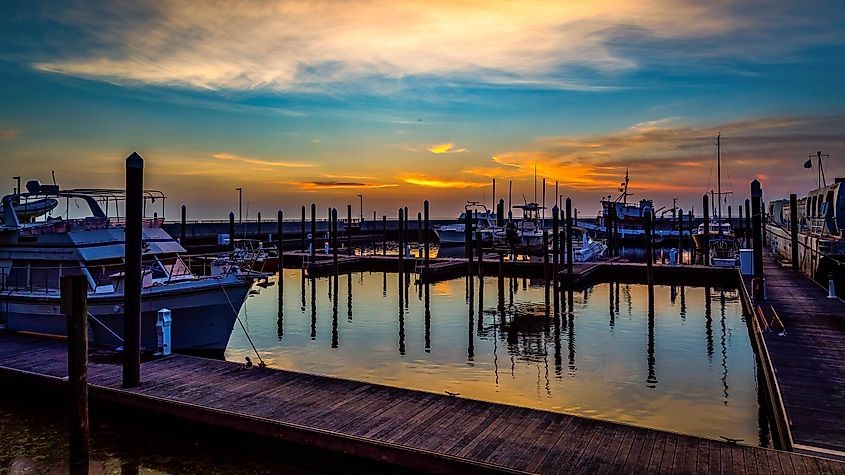 Boats on Lake Okeechobee create a peaceful scene. The lake's vastness is evident, even though it is smaller than Lake Michigan.