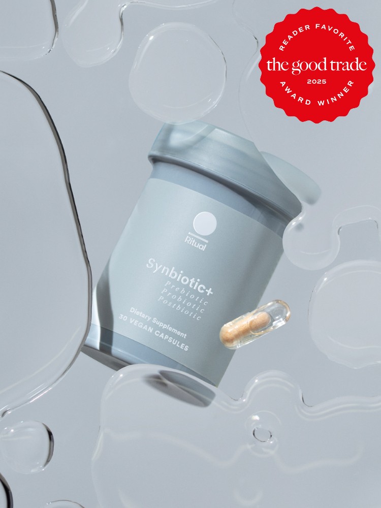 A jar of Ritual Synbiotic+ dietary supplement with a single capsule floating mid-air, surrounded by abstract liquid shapes. The image features an award badge from The Good Trade, marked as Reader Favorite 2023.