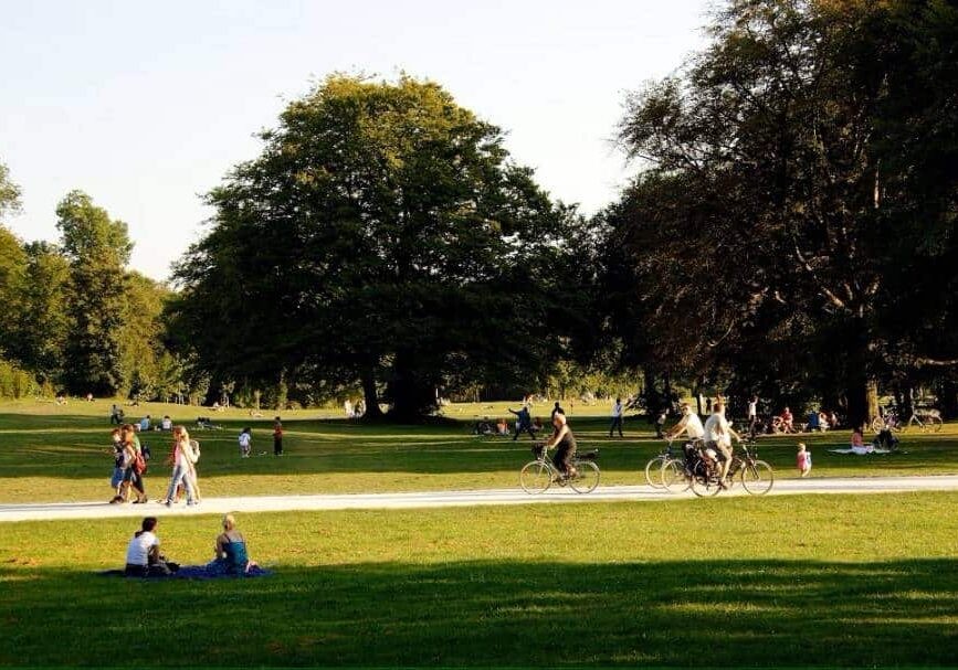 People walking and biking in green park - social progress in the richest countries