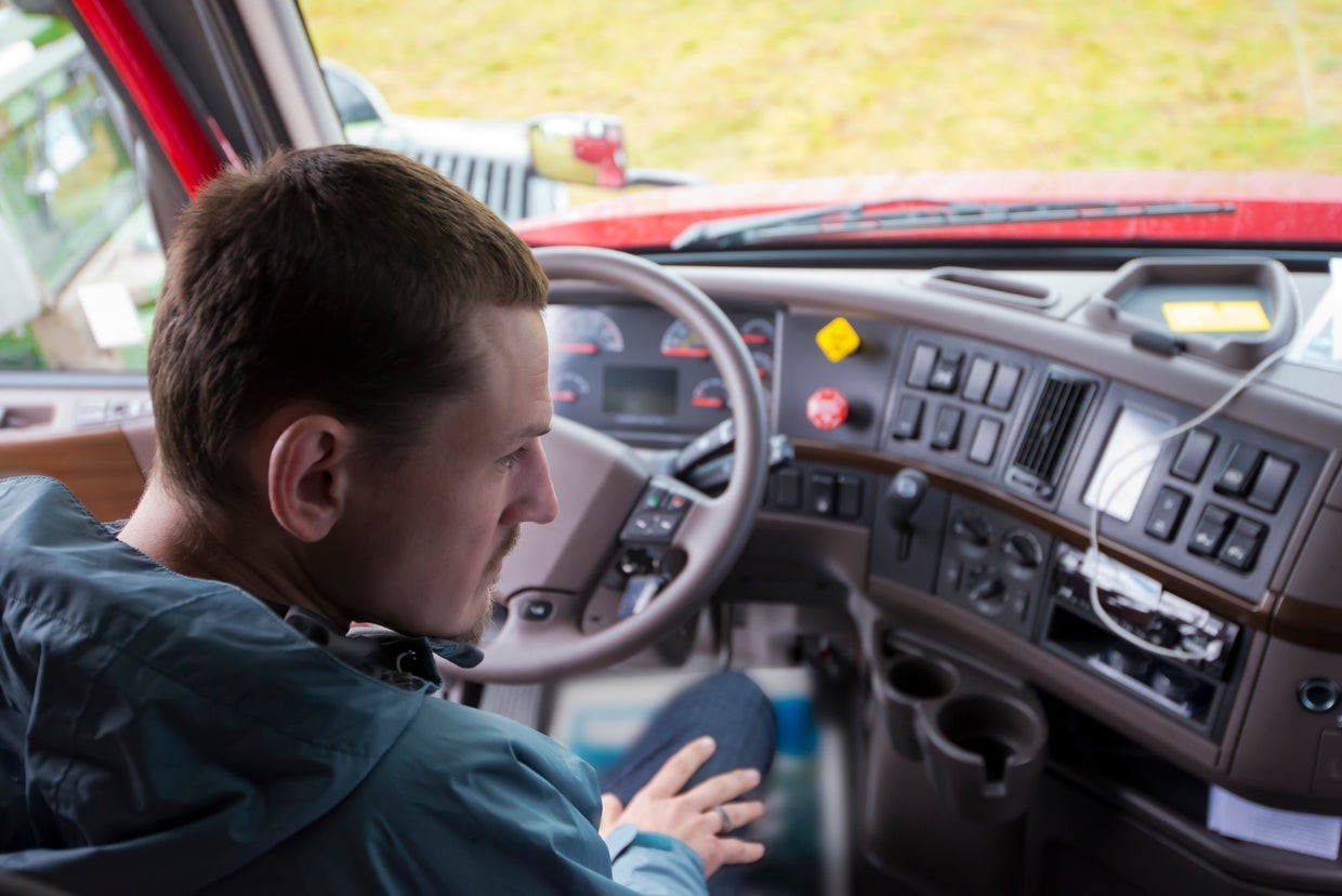 Truck driver behind the wheel of a semi-truck