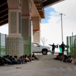 Border Patrol agents watch over detained migrants near El Paso, Texas, on May 19, 2019