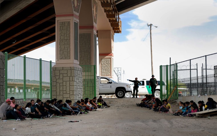 Border Patrol agents watch over detained migrants near El Paso, Texas, on May 19, 2019