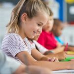 Smiling student completing an assessment