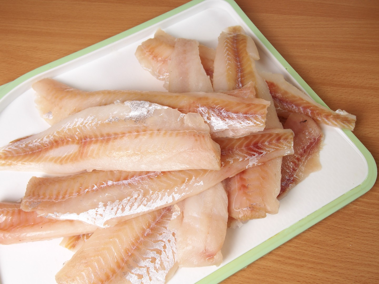 Alaska Pollock fillets on a cutting board