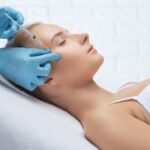 Woman considering facial aesthetic treatments: deciding between Daxxify vs Botox based on her needs