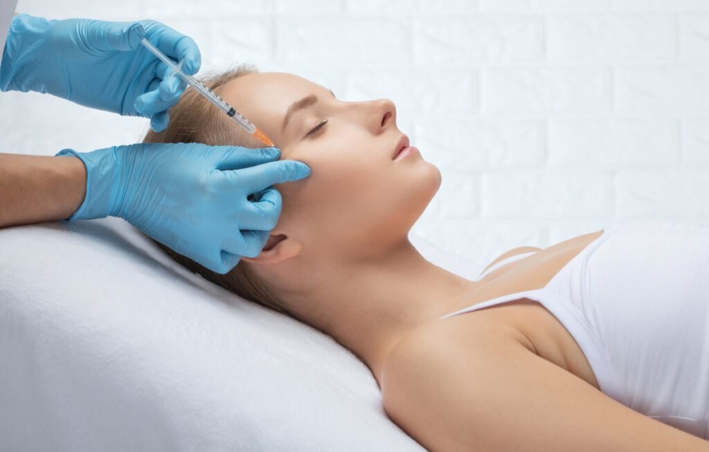 Woman considering facial aesthetic treatments: deciding between Daxxify vs Botox based on her needs