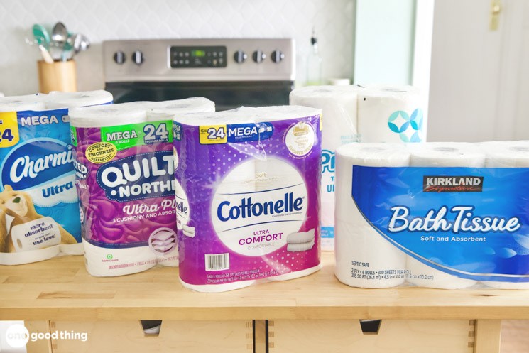 various brands of toilet paper sitting on a table
