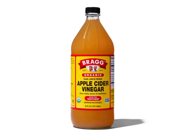 Comparison image showing Nature's Intent and Bragg's apple cider vinegar bottles side-by-side, highlighting key differences in packaging and branding