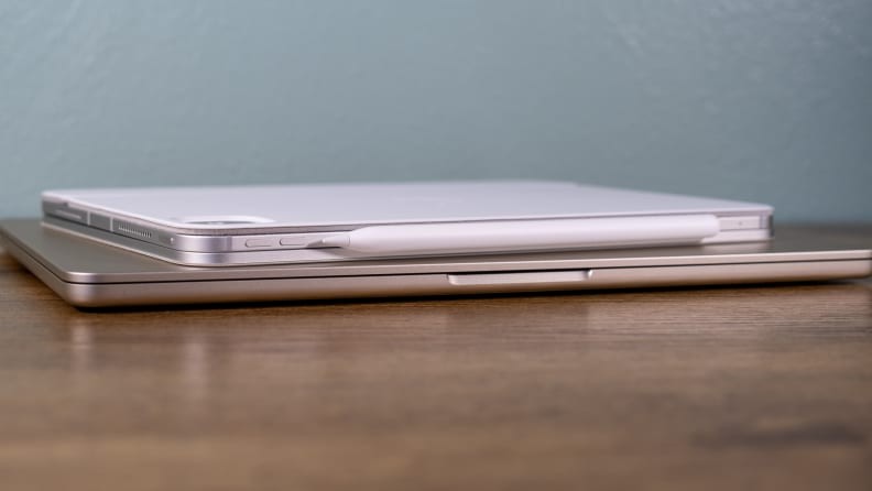MacBook Air and iPad Pro on a desk showcasing keyboards, illustrating the "MacBook Air and iPad Pro form factor comparison" with semantic SEO keywords for optimal search engine visibility