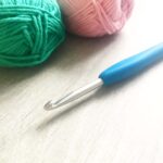 Pink and green cotton yarn and crochet hook
