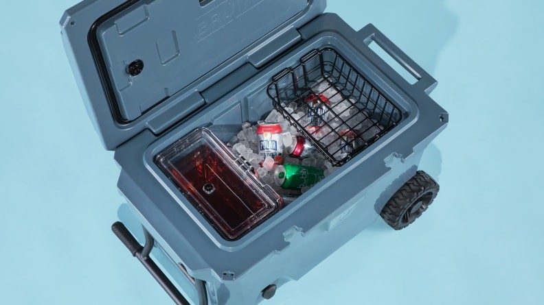 Brümate BruTank 55-quart Rolling Cooler on a blue background, showcasing its all-terrain wheels