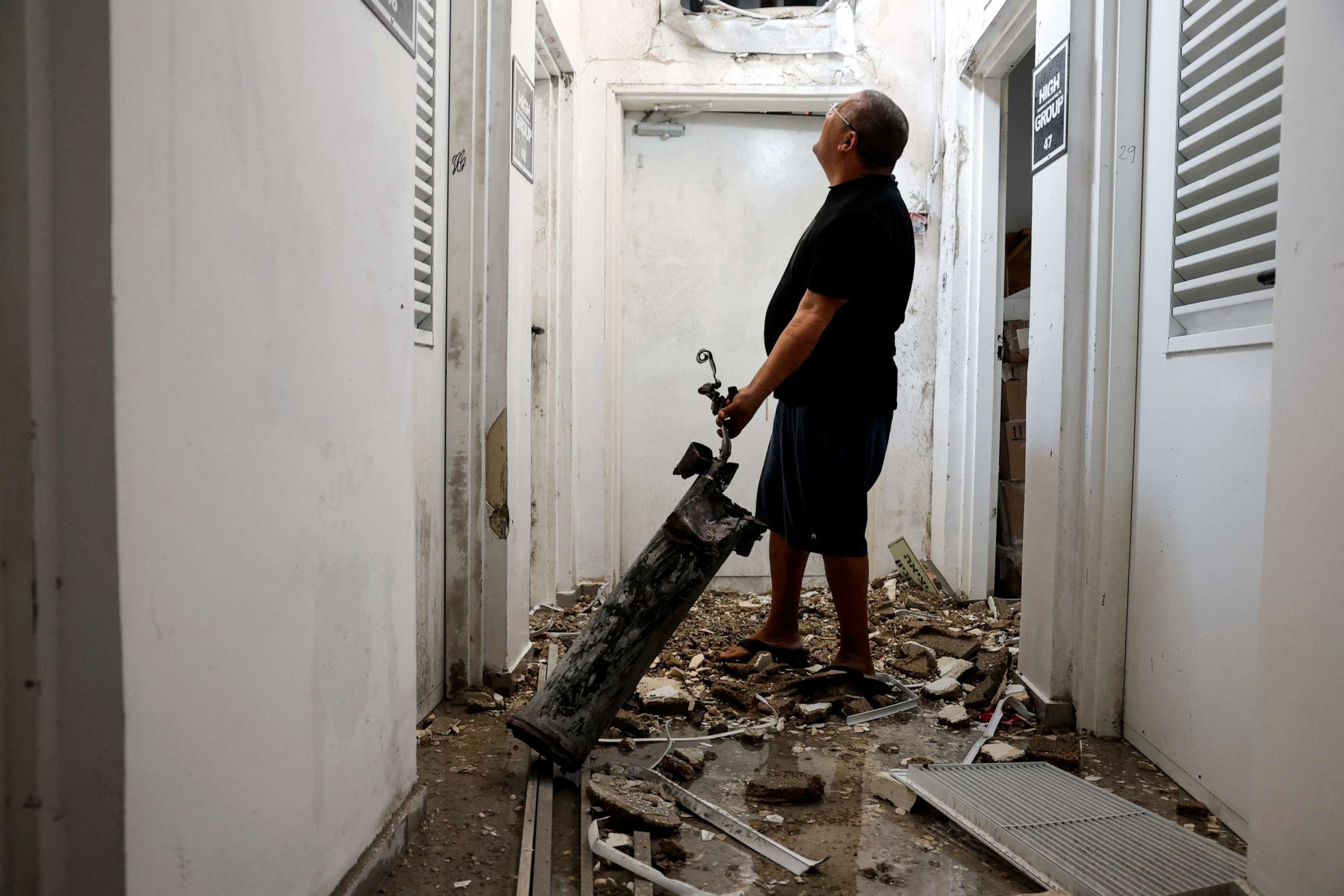 A man holds the remains of a rocket that was launched from the Gaza Strip and landed in Ashkelon, southern Israel, Oct. 11, 2023.