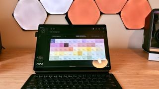 ASUS ProArt PZ13 on a wooden desk, highlighting its versatility as a 2-in-1 device