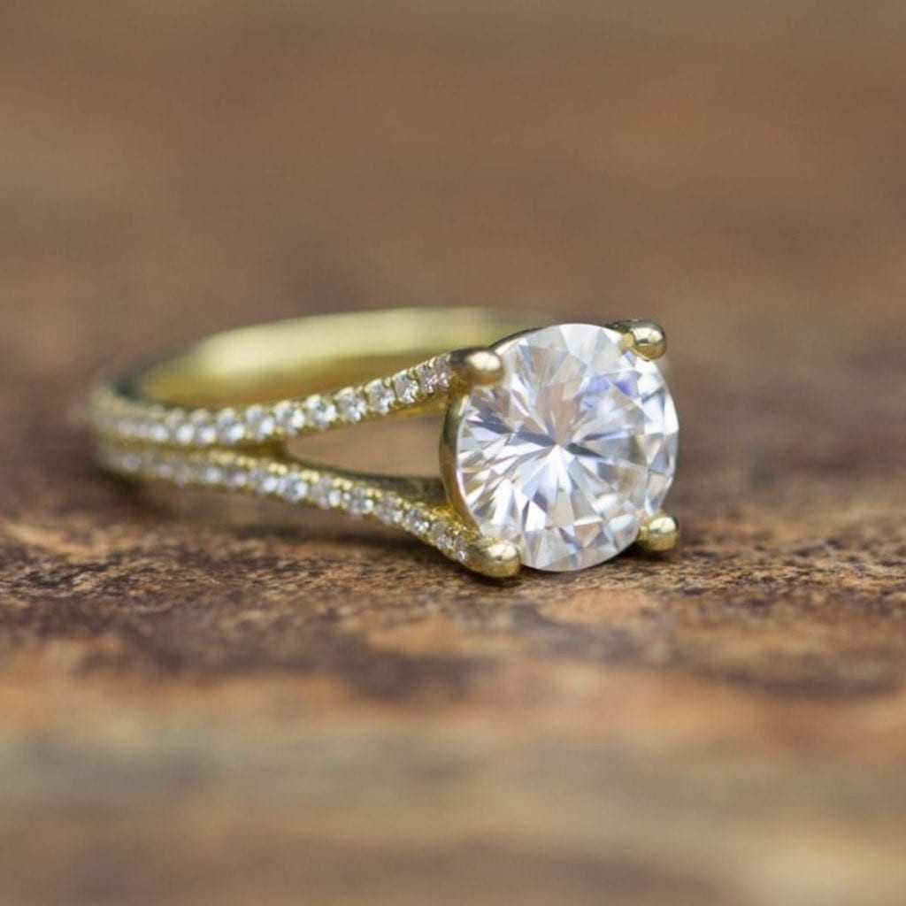 A large moissanite center stone in a ring setting