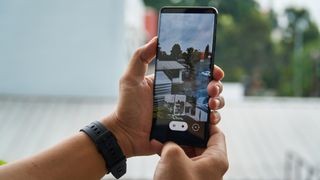 Hand holding a phone with photo on the display