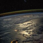 Astronaut Karen Nyberg's stunning image of Mauritius and Réunion at night from the ISS, highlighting the vastness of Earth compared to human scale, captured in 2013