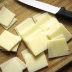 Monterey Jack cheese sliced on a chopping board