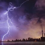 Lightning storm at night, illuminating the landscape