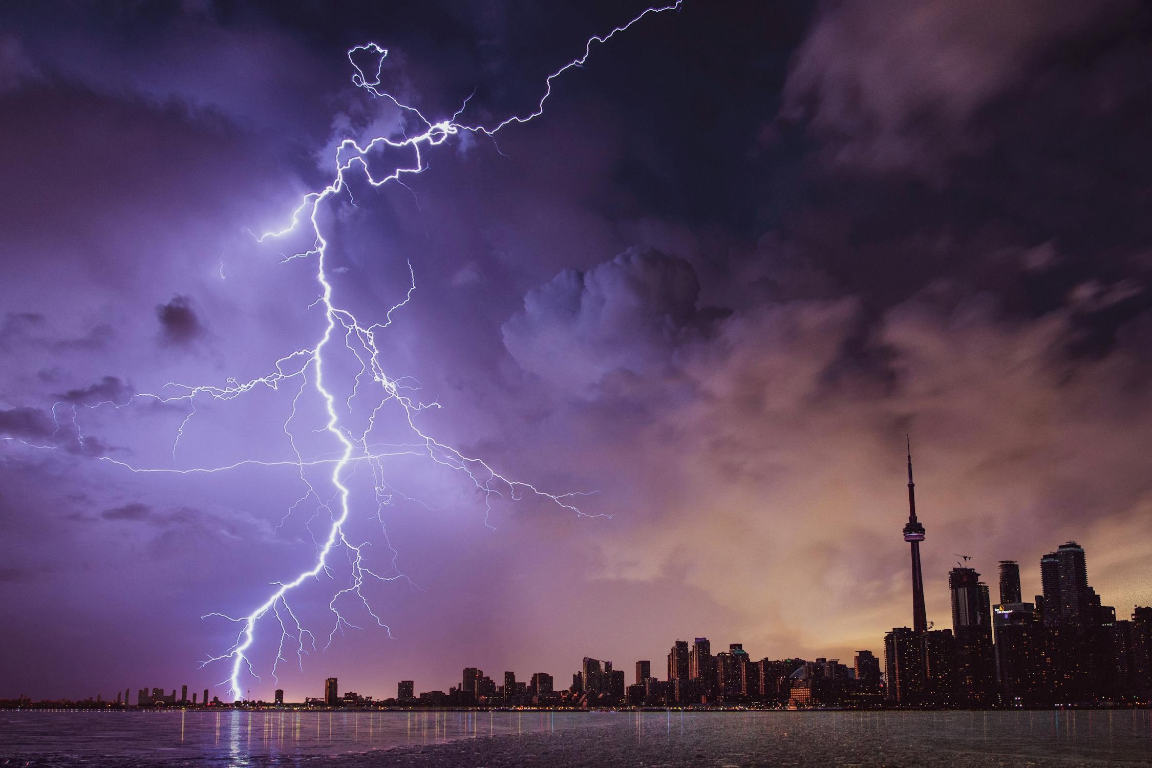 Lightning storm at night, illuminating the landscape