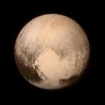 Pluto is reddish and has a heart shape lighter patch in the lower right half of this image from the New Horizons spacecraft, the heart of Pluto.