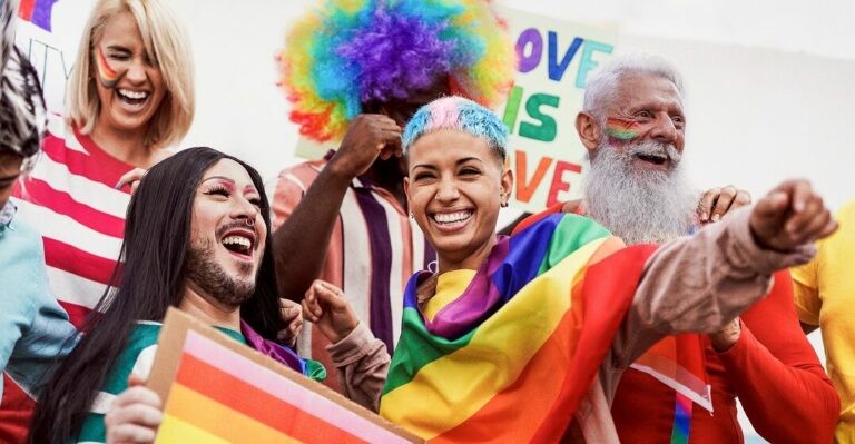 Two women looking at art during a festival celebrating diversity.