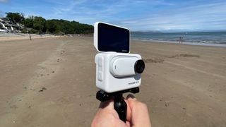 Insta360 GO 3 action camera on a beach