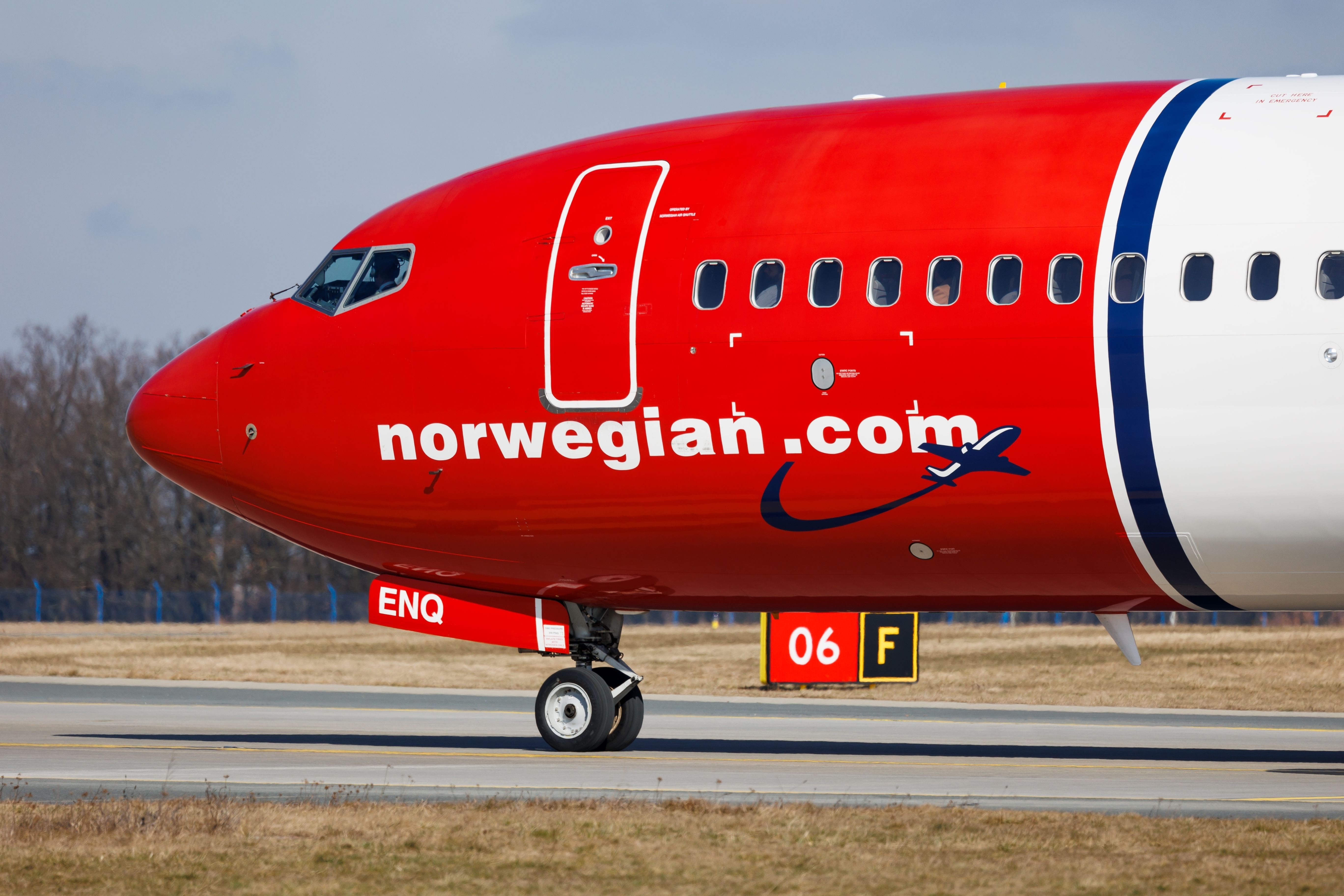 A Closeup of the nose of a Norwegian Boeing 737 on an airport apron.