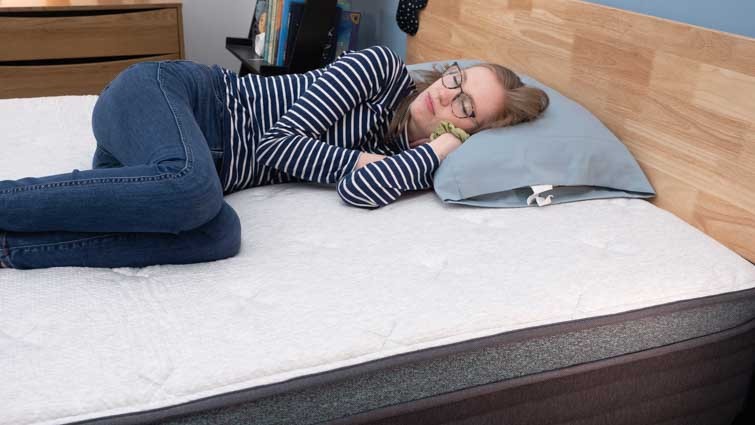 Side sleeper demonstrating comfort on the Helix Sunset Luxe Mattress