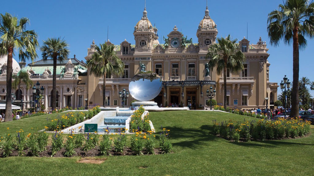 Monte Carlo Casino in Monaco with fountain and palm trees