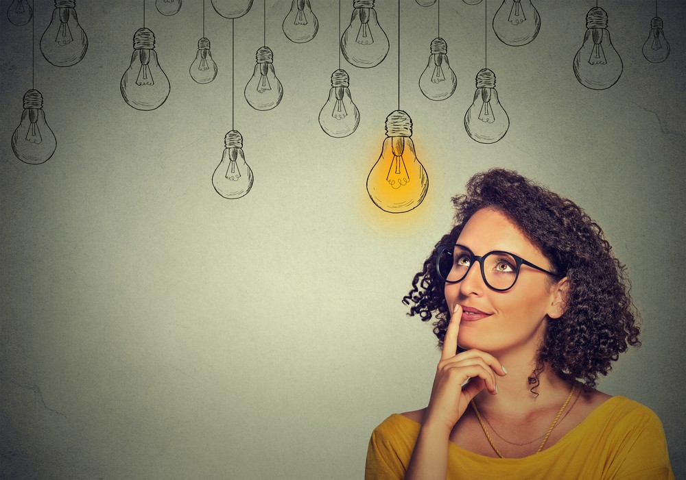 Thinking woman with light bulb idea